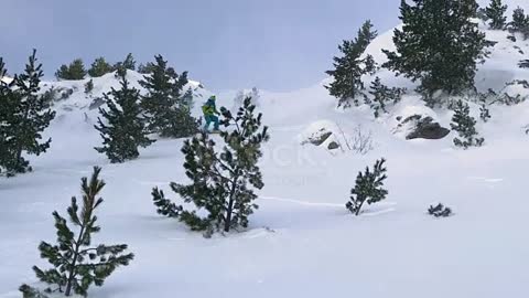 Extreme male skier riding off piste jumps and crashes into the fresh powder snow