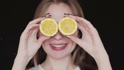 The beautiful girl is smiling. Lemons in the eyes.