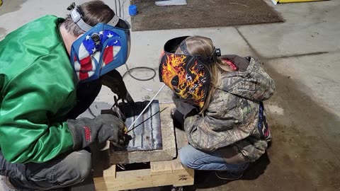 Little Girl Welding Footstool out of Files and Horseshoes