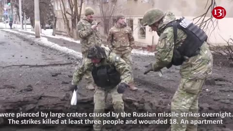 People wounded in Kramatorsk strikes groan in pain as they receive treatment on snowy ground