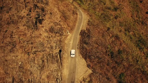 The car in the middle of the mountains is fun