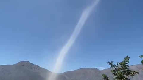 Person Witnesses Dust Devil Formation While Hiking in Mountains of Chile