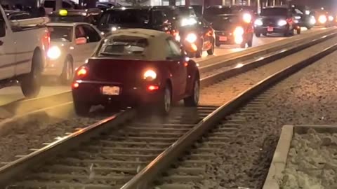 Car Drives Down Train Tracks