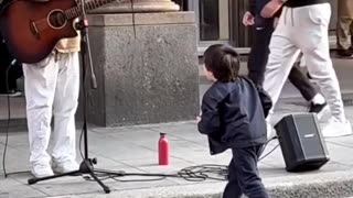 child with a street singer