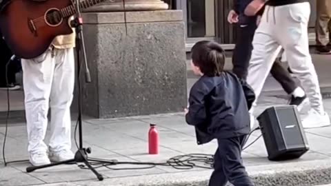 child with a street singer