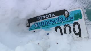 Car wedged in Minneapolis snowbank