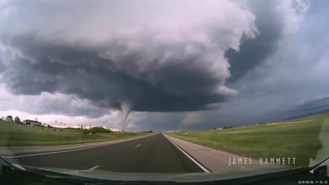 Storm chasing dashcam: Tornado crossing the highway! Laramie, Wyoming