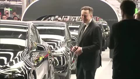 Dancing Musk hands out first Teslas from new factory