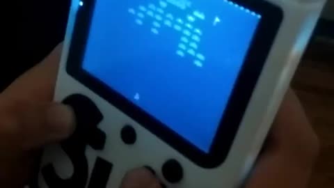 "Game boy" style retro-console with Galaxian game...