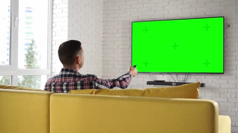 Man Watches Tv Set Green Screen _ Free Video Stock Footage _ Creator Stockify