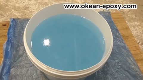 Pouring OKEAH pro epoxy into a river table.