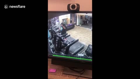 Terrifying moment car smashes through gym into man on treadmill