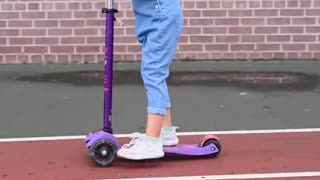 girl riding a kick scooter