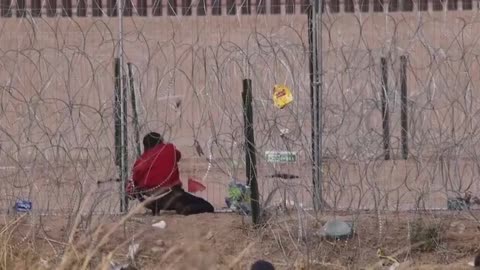Immigrant cuts Texas border cable, then leads dozens of migrants through hole near El Paso.