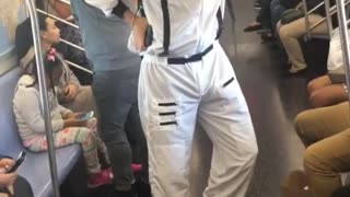 Person dressed as nasa astronaut on subway train
