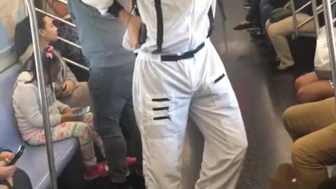 Person dressed as nasa astronaut on subway train