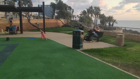 girl runs on the playground at sunset