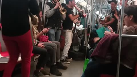 Band playing on subway train