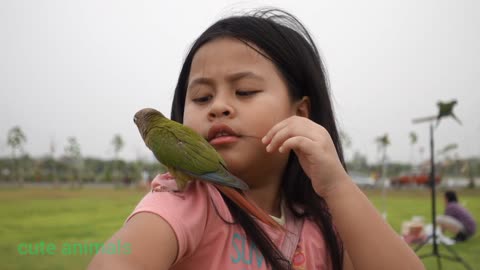 A Girl Holding A Parrot