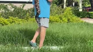 Man Taking a Snake for a Stroll