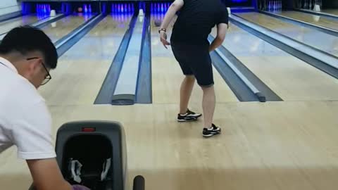 My friend who is practicing bowling.