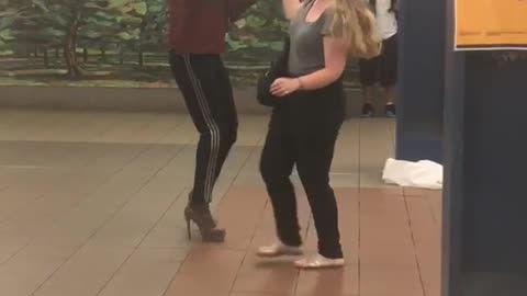 Guy red shirt black hat dancing with grey shirt girl subway