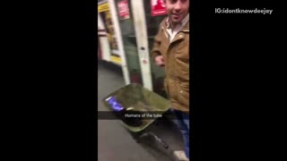 Humans of the tube guy pushes wheelbarrow