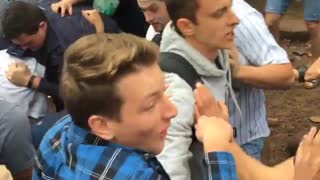 Guy in green shirt punches guy in blue shirt