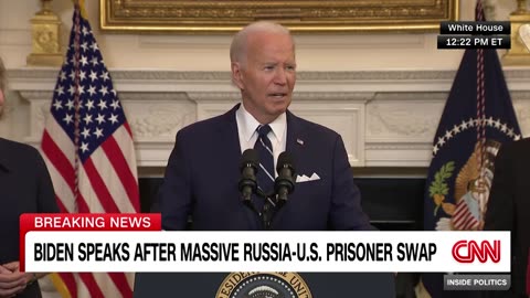Biden speaks while being surrounded by family members of the swap