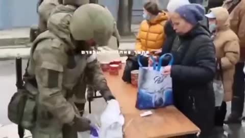 Russian military giving food to Ukrainian people