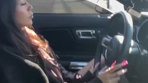 Beautiful girl driving a Ford Mustang