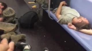 Several homeless people asleep on subway