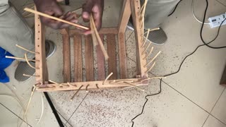 Rattan weaving on wood.