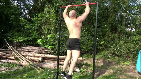 Bodybuilder does 50 Pull Ups and 100 Press ups