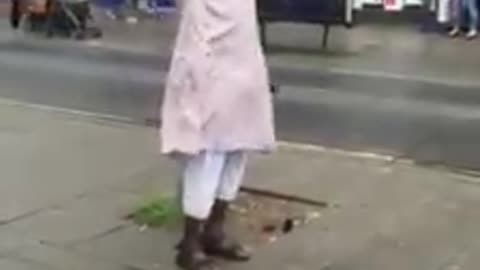 Man reciting Adhan in the street - UK