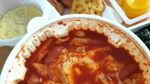 Korean mukbang tteokbokki, sundae, steamed eggs, and fried food.