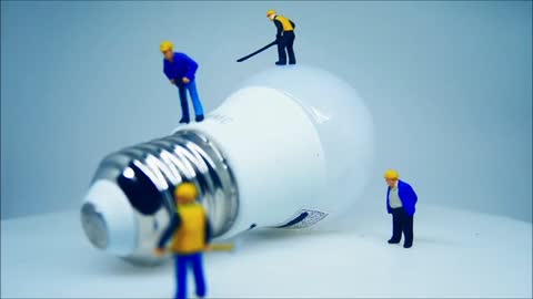 Close-up View Of A Lightbulb And Miniature Toys