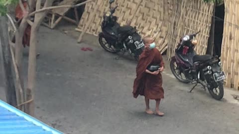 Monks Walking Barefoot Begging on the Street for Food in Myanmar