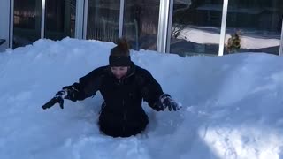 Girl black sweats jumps off roof buried in snow to waist