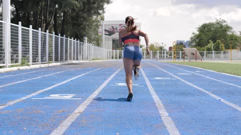 Lady running quick on a running track