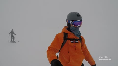 Snowboarder rides down slope almost crashes into friend, trips and falls down, gopro