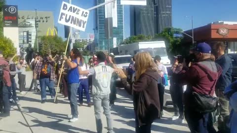 EPIC Moment As Counterprotestors Show Up To Netflix Walkout Holding "Jokes Are Funny" Signs