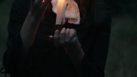 A Girl Holding a Lighted Candle