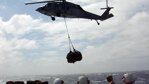 SH-60 Seahawk lifting cargo off of the flight deck of USS HARPERS FERRY