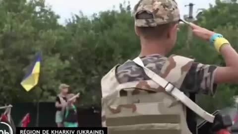 UKRAINIAN CHILDREN ACCOMPANY A MILITARY CONVOY WITH A NAZI SALUT