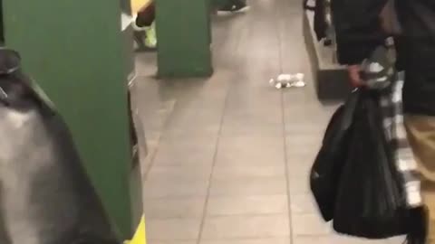Shirtless black guy doing pushups on rail with black earphones on