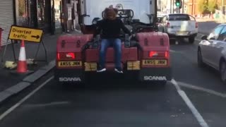 Man Wearing Bear Mask Catches a Ride