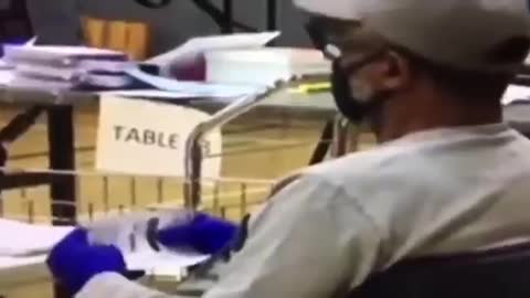 Election worker fills in ballots