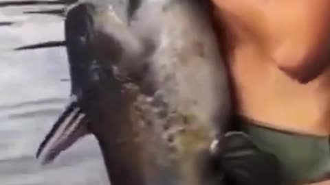 Woman catches big fish with her hands