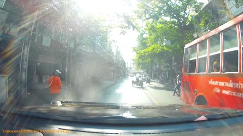 Motorist Has Close Call with Oncoming Bus